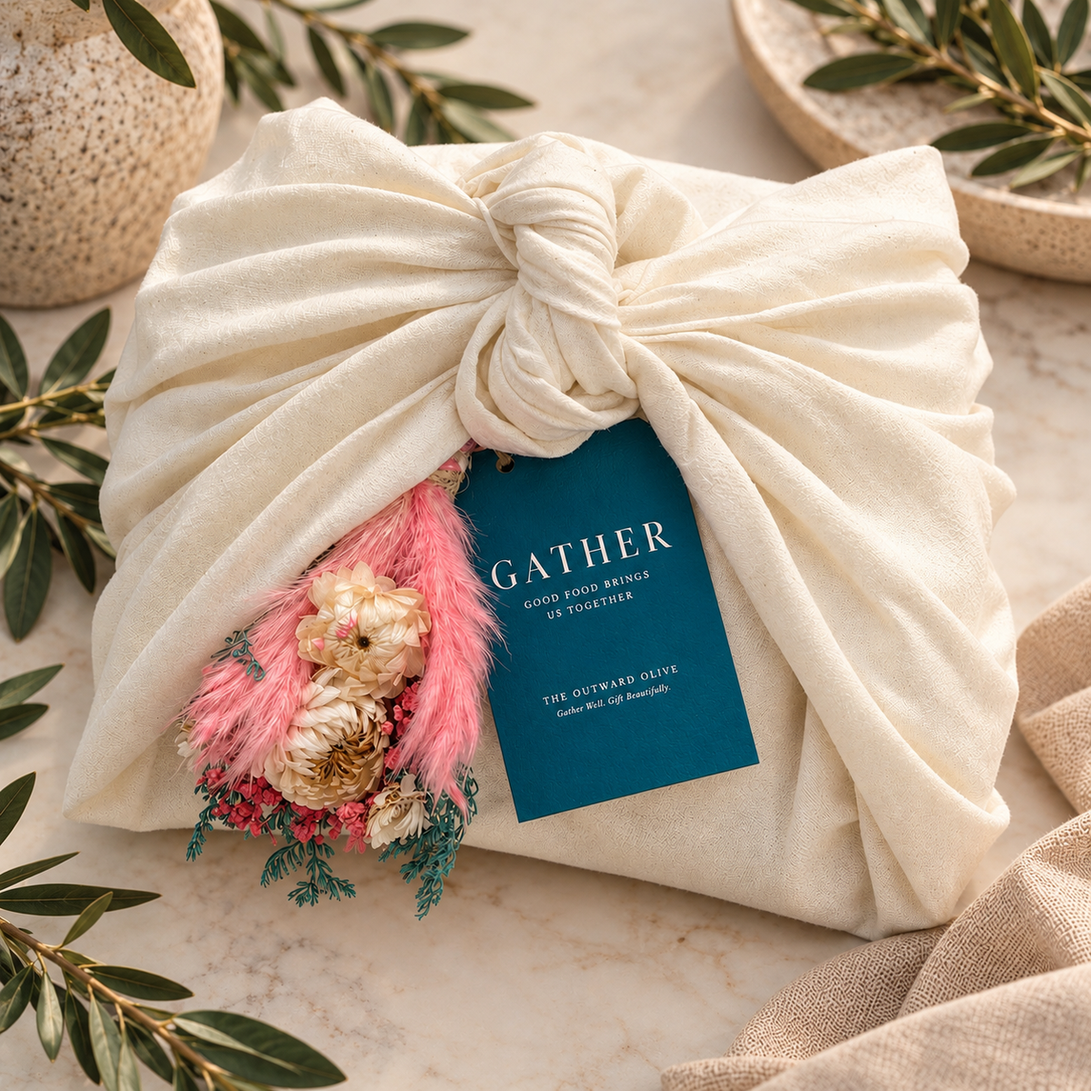 Gather gift set wrapped in a cream cotton tea cloth with dried florals and a navy hang tag