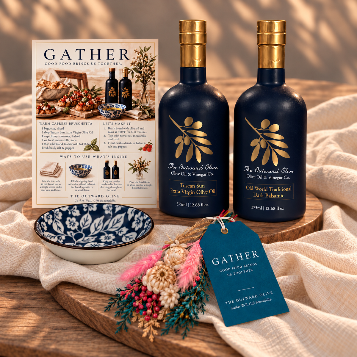 Tuscan Sun Extra Virgin Olive Oil and Old World Traditional Dark Balsamic with a blue and white dipping bowl and recipe card