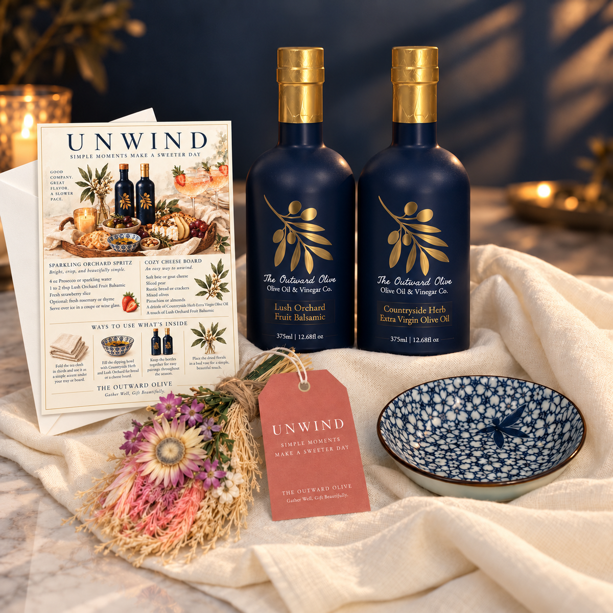 Countryside Herb Extra Virgin Olive Oil and Lush Orchard Fruit Balsamic with a blue and white dipping bowl and recipe card